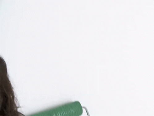 Person Painting Green Wall with Roller