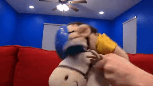 Person Petting Stuffed Animal on Couch