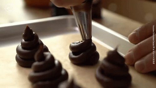 Person Piping Chocolate Cookies