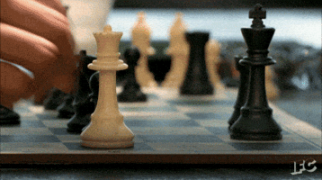 Person Playing Chess With King and Queen