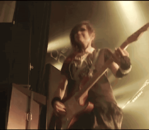 Person Playing Guitar With G On Chest GIF
