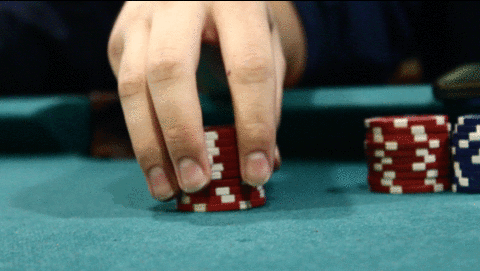 Person Playing Poker with Red and White Chips