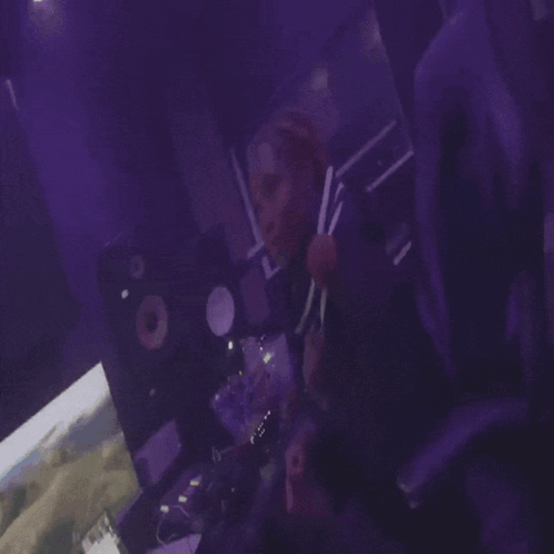 Person Playing Video Game In Dark Room With Purple Lights GIF