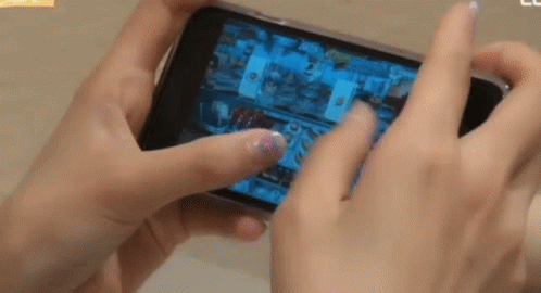 Person Playing Video Game on Cell Phone