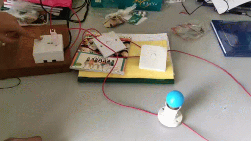 Person Plugging Light Bulb Into Switch GIF