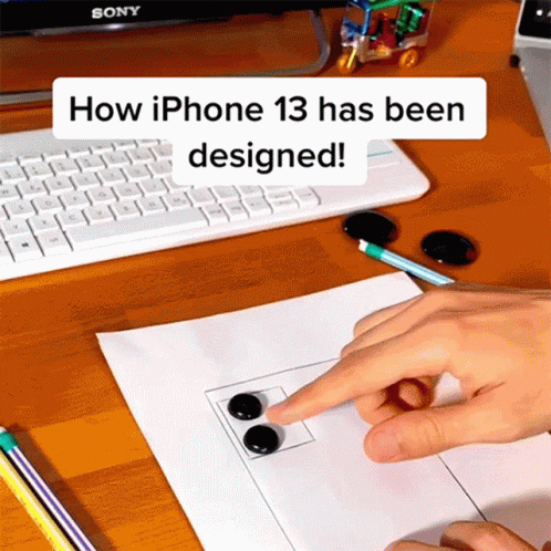 Person Pointing At Paper How IPhone 13 Has Been Designed GIF