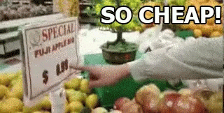 Person Pointing at Special Fuji Apples $4.00 Sign