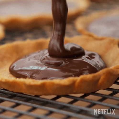 Person Pouring Chocolate Behind Netflix Logo