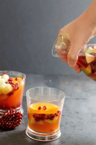 Person Pouring Drink Into Glass
