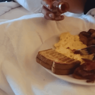 Person Pouring Syrup on Food