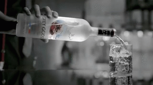 Person Pouring Vodka Into Glass GIF