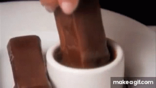 Person Putting Chocolate Bar In Hot Chocolate GIF