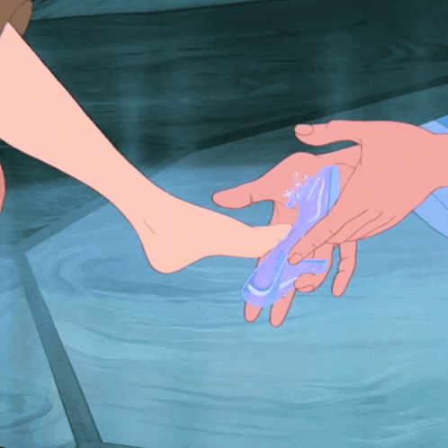 Person Putting Shoe on Another