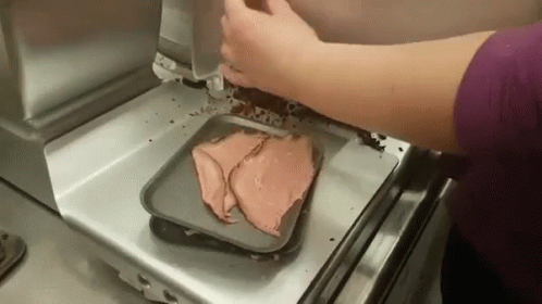 Person Putting Sliced Meat on a Tray