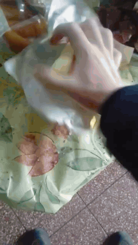 Person Putting Something in a Plastic Bag
