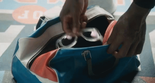 Person Putting Sunglasses In Blue Bag GIF