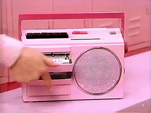 Person Putting Tape in Pink Radio