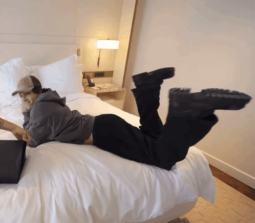 Person Reading Book Lying on Bed