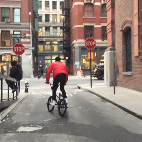 Person Riding Bike at Stop Sign