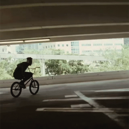 Person Riding Bike in Parking Garage