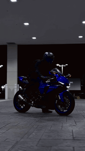 Person Riding Blue Yamaha Motorcycle