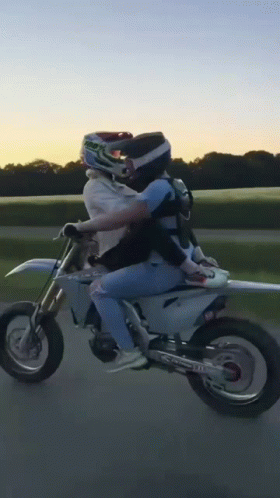Person Riding Dirt Bike With Passenger