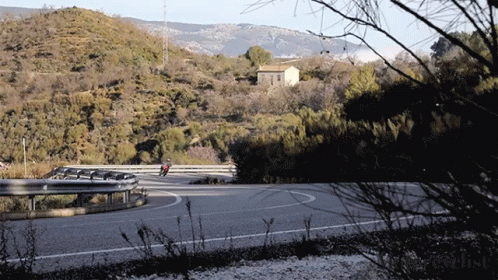 Person Riding Motorcycle on Curvy Road