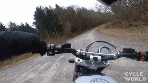 Person Riding Motorcycle on Dirt Road Cycle World