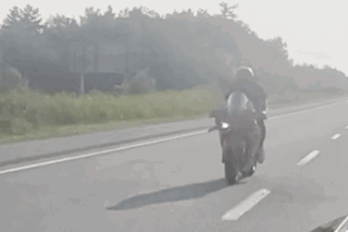 Person Riding Motorcycle on Highway