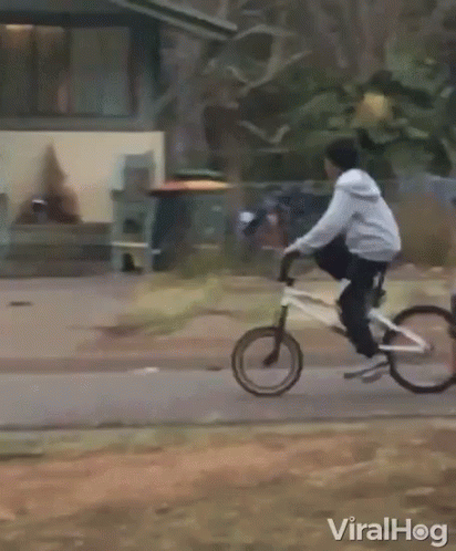 Person Riding Motorcycle Past Building Saying A & A
