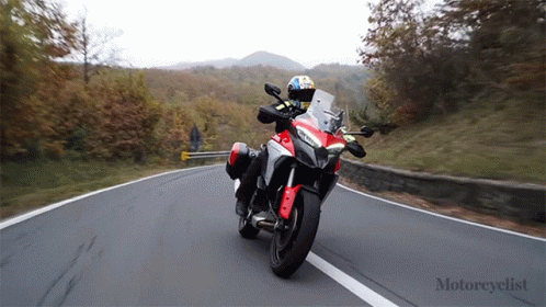 Person Riding Red and White Motorcycle Motorcyclist