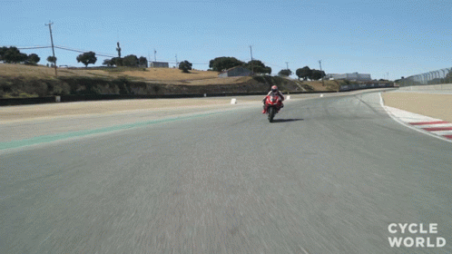 Person Riding Red Motorcycle on Track Cycle World