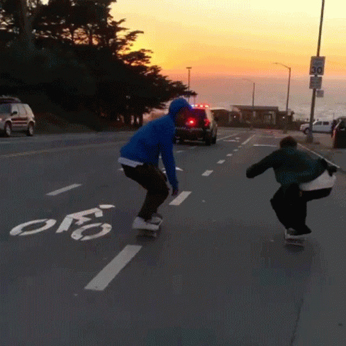 Person Riding Skateboard On Street With Bike Lane GIF