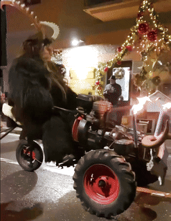 Person Riding Tractor on Street at Night