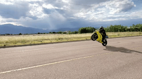 Person Riding Yellow Motorcycle