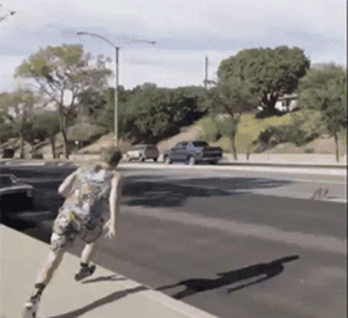 Person Running Down Street With Blue Truck