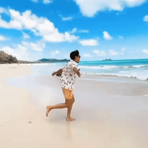 Person Running On Beach With Arms Outstretched GIF