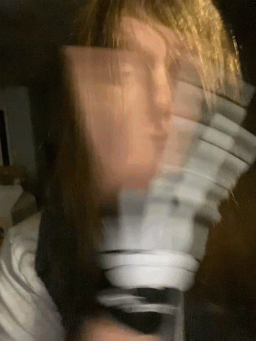 Person's Blurry Face With Cards Behind