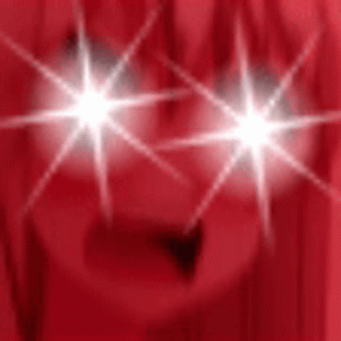 Person's Eyes Shining On Red Background GIF