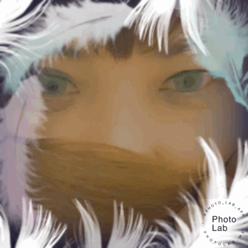 Person's Face Surrounded By White Feathers GIF