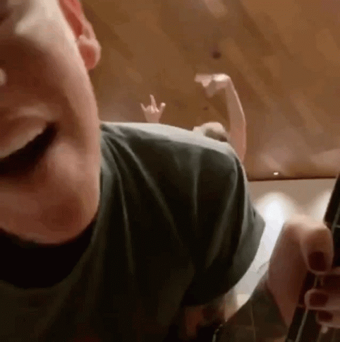 Person's Face With Peace Sign Hand