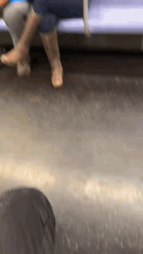 Person's Feet Sitting on Train
