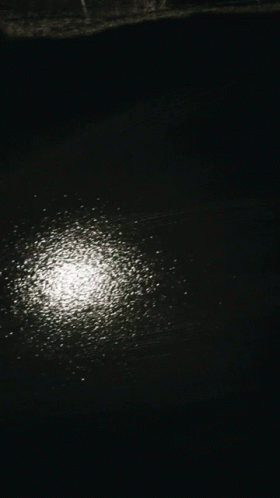 Person's Hand on Black Surface with White Dots