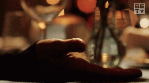 Person's Hand Rests on Table With BETV Logo