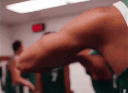 Person's Leg In Locker Room With Red Exit Sign GIF