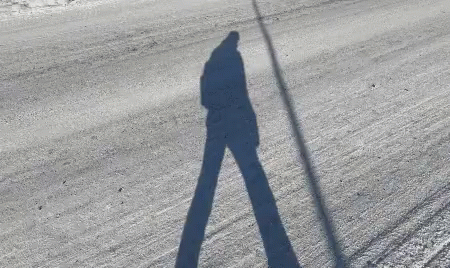 Person's Shadow on Snowy Road