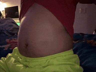 Person's Stomach With Red Shirt and Neon Green Shorts