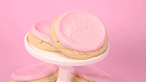 Person Scooping Ice Cream Into Cookie