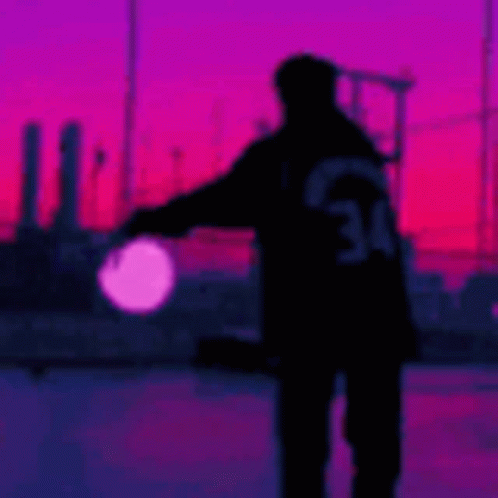 Person Silhouette Holding Light At Sunset GIF