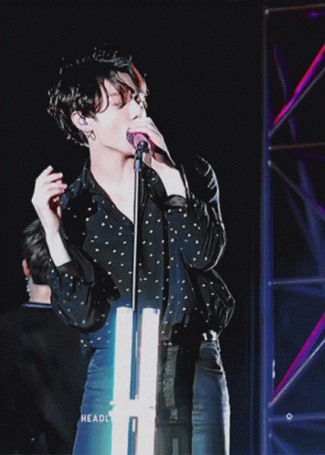 Person Singing Into Microphone With Headl